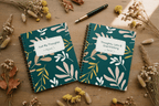 A5 spiral notebook set with teal botanical covers and handwritten-style title labels