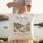 White canvas tote bag being held, with personalized script name and watercolor harbor print