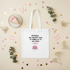 White tote bag with birthday cake quote print and pink cake graphic, long handles