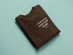 Crewneck sweatshirt in chocolate brown with "I survived another year" graphic