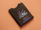 Dark brown crewneck sweatshirt with 'Sarah's Garden' floral crest print.