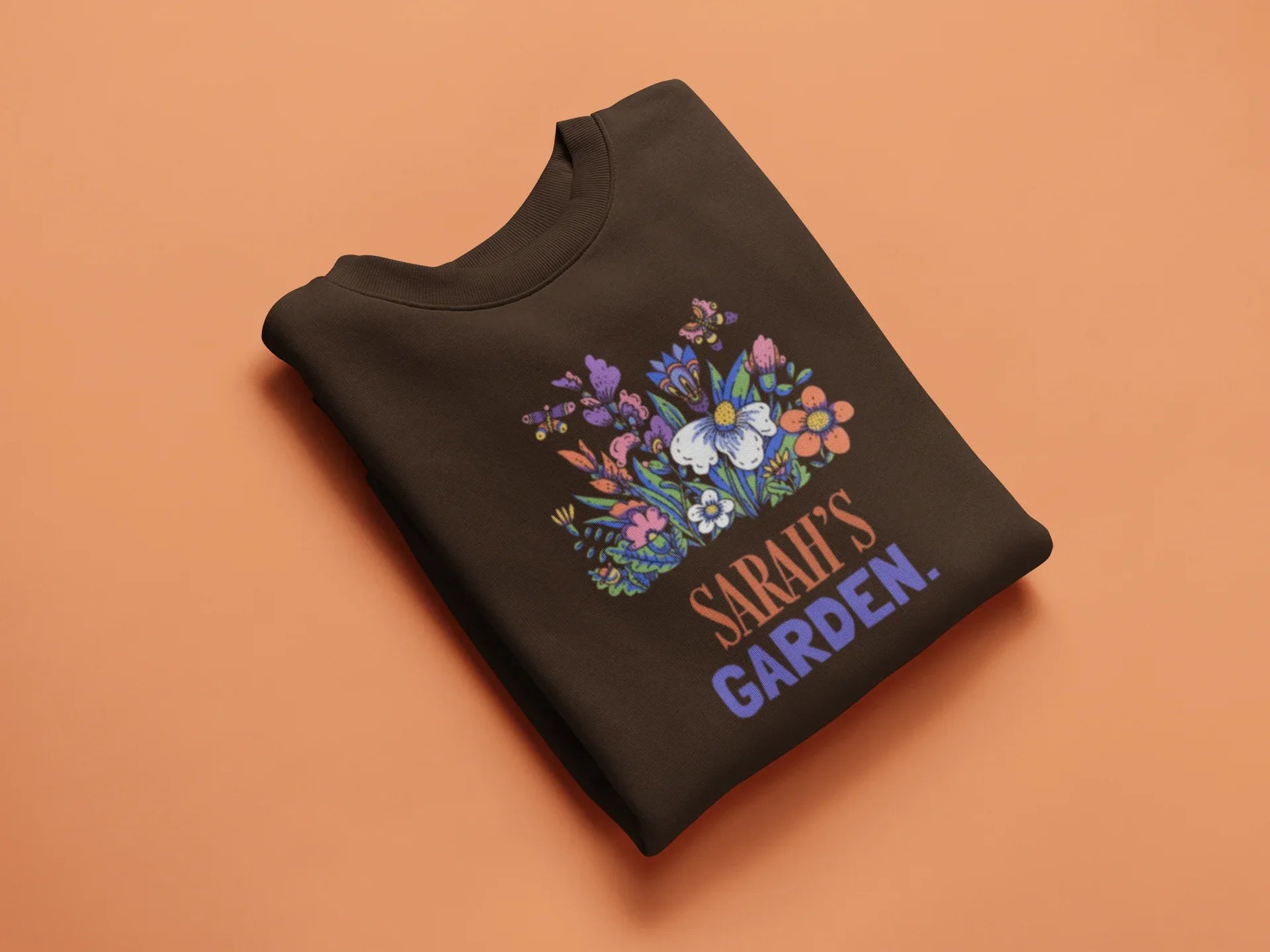 Dark brown crewneck sweatshirt with 'Sarah's Garden' floral crest print.