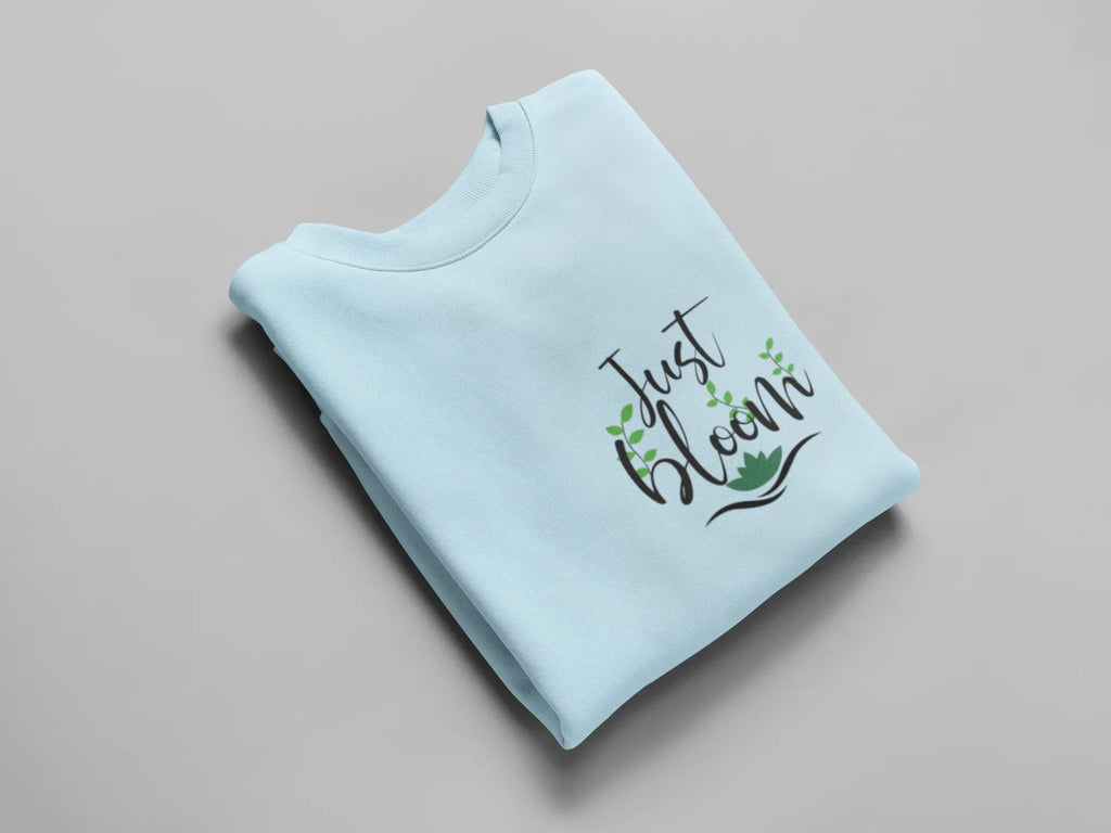 Light blue crewneck sweatshirt with floral “Just Bloom” graphic