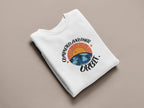 White crewneck sweatshirt with arched space graphic and “Orbit!” wordmark