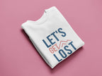 White crewneck sweatshirt with blue and red “LET'S GET LOST” graphic