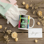 White mug with colorful nature quote on a wooden surface