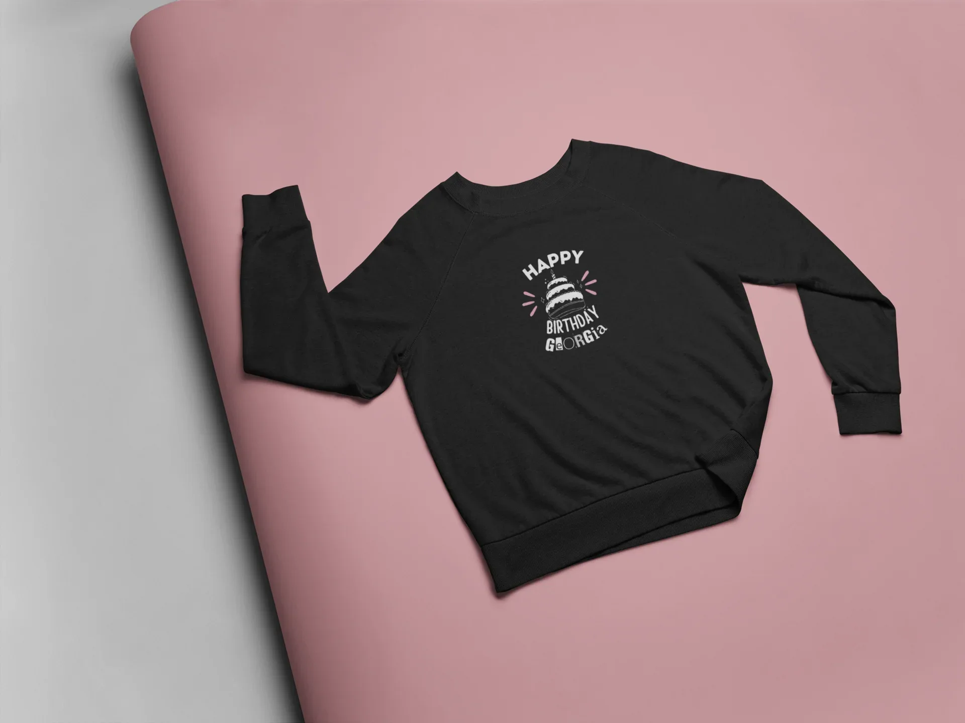 Black crewneck sweatshirt with “HAPPY BIRTHDAY” cake graphic on the chest