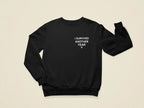 Black crewneck sweatshirt with front text graphic “I SURVIVED ANOTHER YEAR”