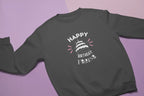Dark gray crewneck sweatshirt with “Happy Birthday” cake and sparkle text graphic