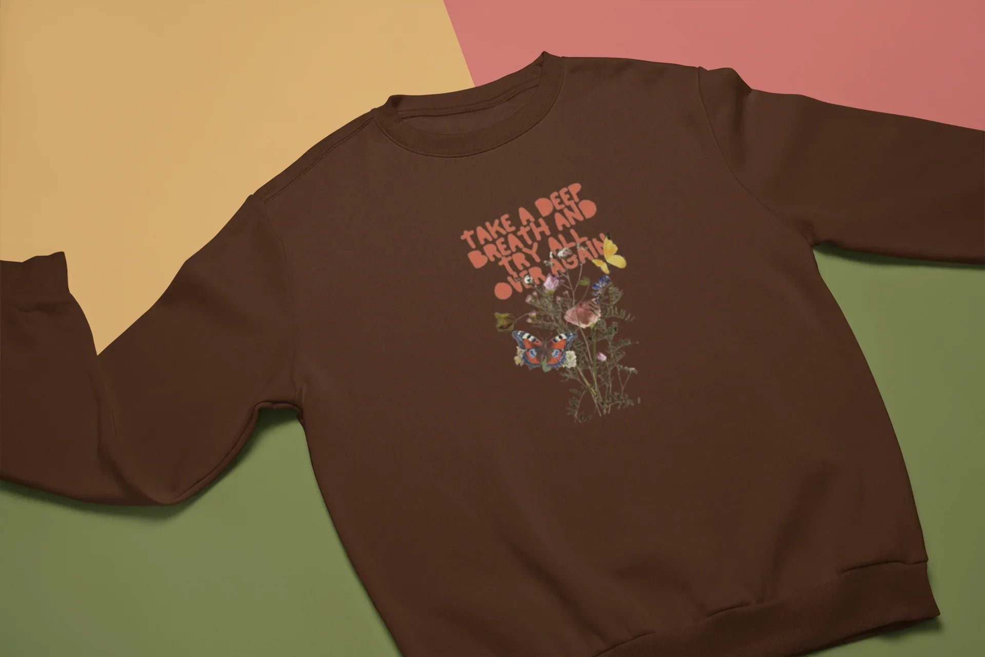 Dark chocolate crewneck sweatshirt with floral inspirational text graphic on chest