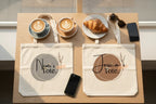 Two cream cotton tote bags with circular 'Tote.' logo prints on display table