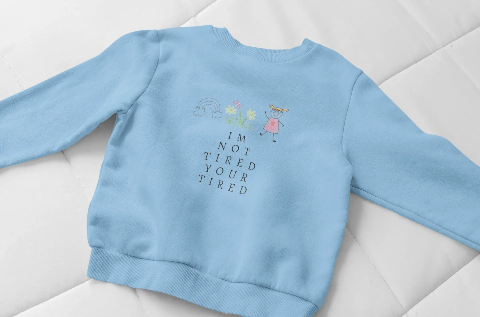 Sky blue kids sweatshirt with 'I'm Not Tired, You're Tired' character graphic