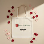 White personalized rose tote bag with red rose print and 'Isla&Uwais' text