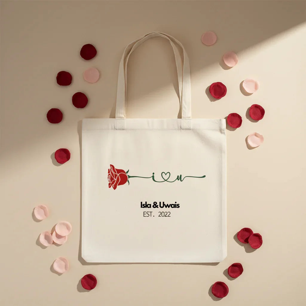 White personalized rose tote bag with red rose print and 'Isla&Uwais' text