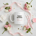 White ceramic mug with “happy birthday” and name Sarah, with heart accents