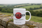 White ceramic mug with “FLETCHER” name print and “Cricket Legend” text, on stone