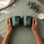 Dark green ceramic mugs with floral line art and printed names ZARA and SHAZIA