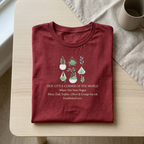 Burgundy botanical t-shirt with succulent and plant motif and “Our little corner of the world”