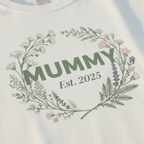 White t-shirt with Mummy floral wreath and Est. 2025 print