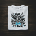 White unisex T-shirt front view with “We Are God’s Creatures” animal graphic print.