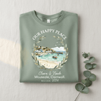 Green T-shirt with scenic landscape wreath graphic and “Clara & Noah” since 2024