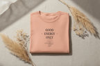 Pink T-shirt with 'Good Energy Only' graphic on the chest, crew neck