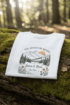 White couples T-shirt with mountain landscape graphic, floral frame, and “James & Rosie”