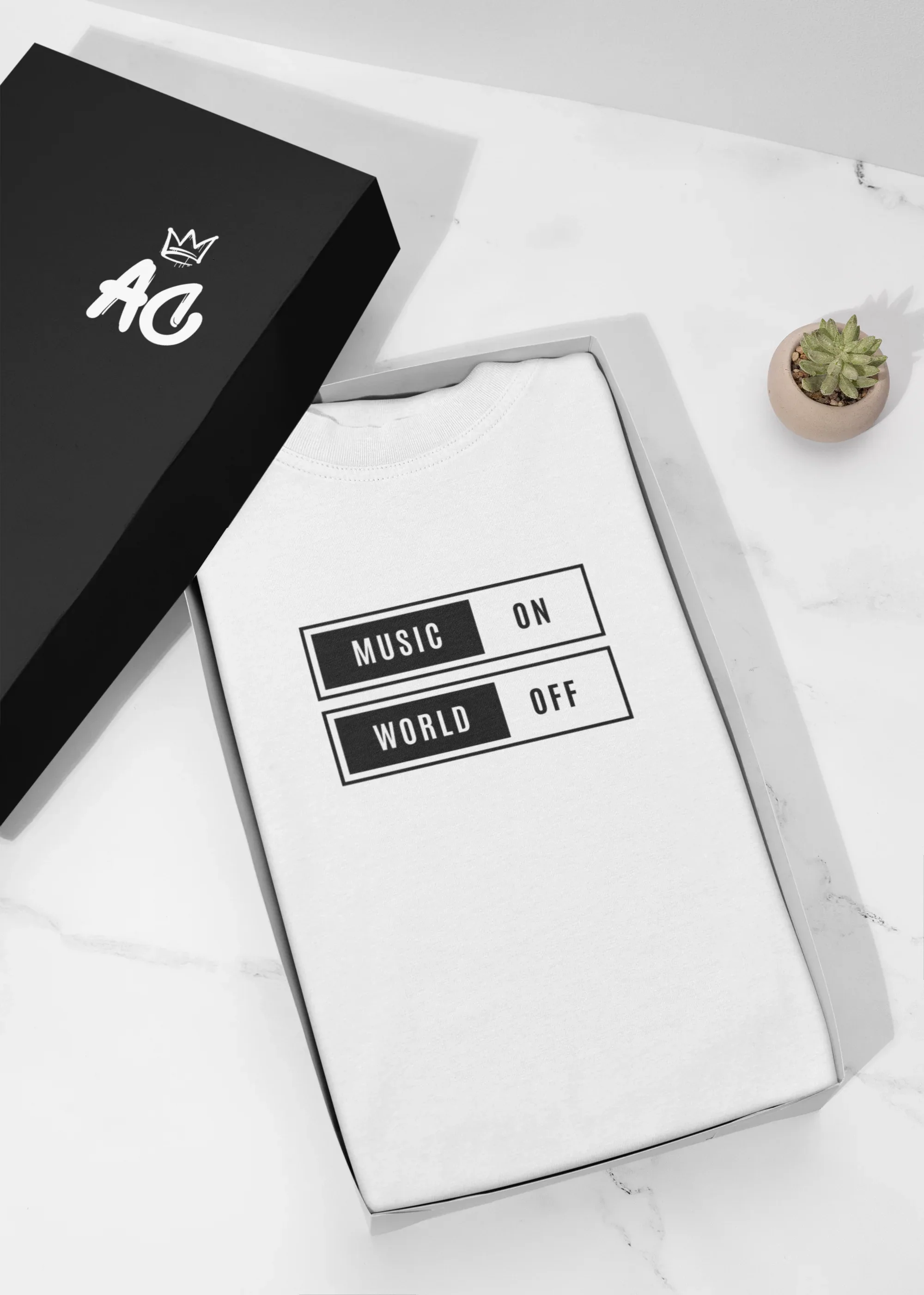 White unisex T-shirt in retail packaging with “Music On / World Off” graphic