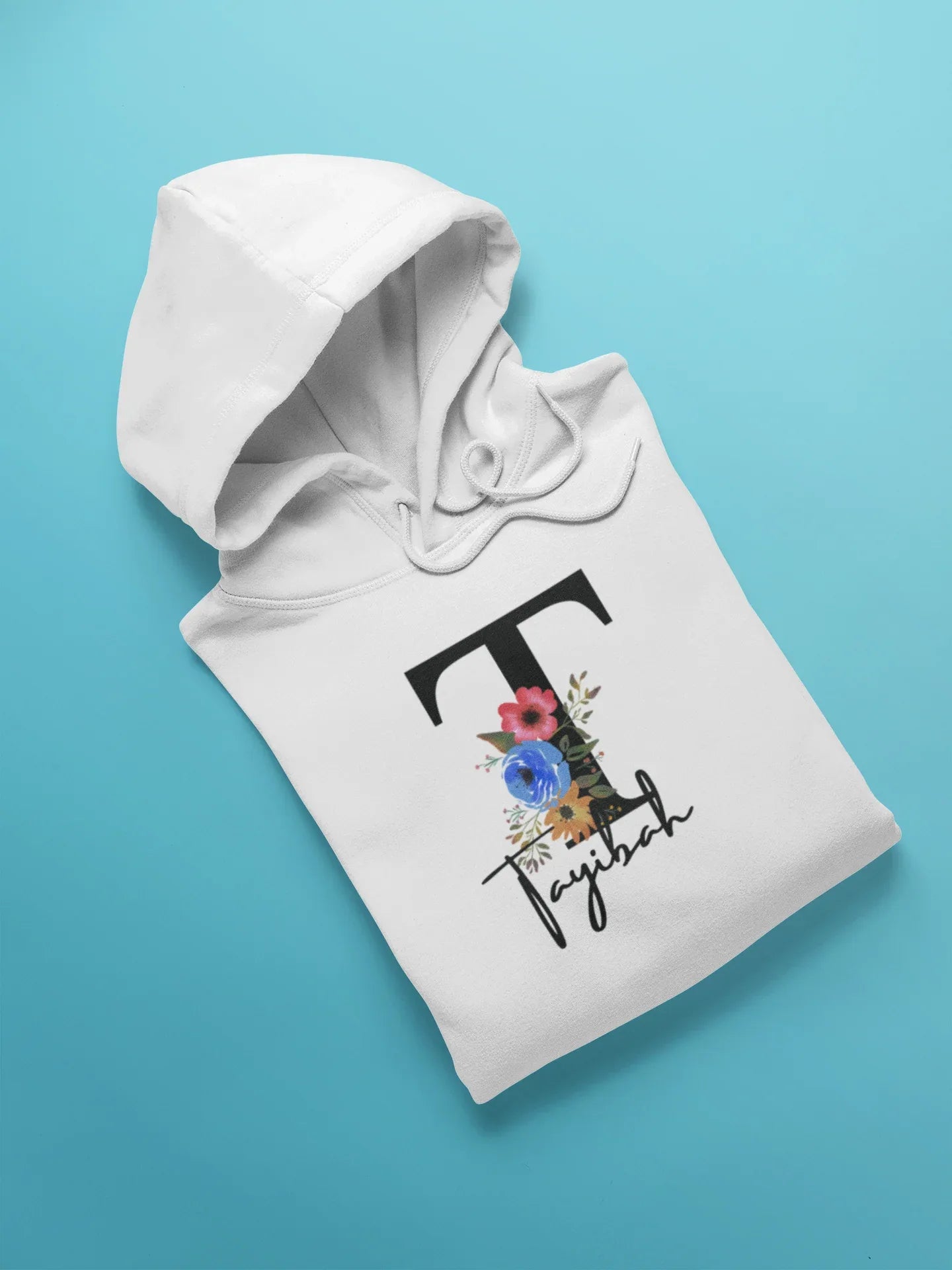 White kids hoodie with hood and front pocket, floral letter and script name graphic