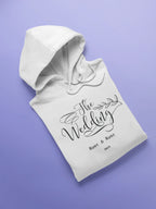 White wedding day hoodie sweatshirt with “The Wedding” front logo and kangaroo pocket