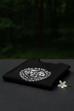 Black T-shirt folded with Save the Planet emblem on chest, crew neck