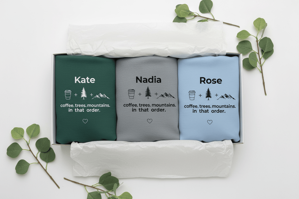 Folded crewneck sweatshirts set with personalized name text and coffee/trees/mountains graphic.
