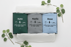 Folded crewneck sweatshirts set with personalized name text and coffee/trees/mountains graphic.