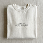 White personalised sweatshirt folded, “meet me here” Mount Snowdon place name print