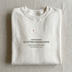 White personalised sweatshirt with “meet me here” Scottish Highlands place name print