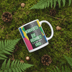 White ceramic mug with green “Introverted” and “Outdoorsy” text graphic on outdoor scene.
