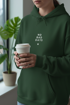 Green hooded sweatshirt on person holding a drink cup; “No Bad Days” chest graphic