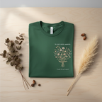 Personalised forest green t-shirt with small floral tree graphic and "In my own season" text