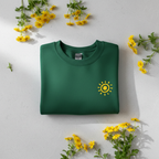 Forest green crewneck sweatshirt with yellow sunburst graphic on the front