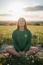 Dark green crewneck sweatshirt with a yellow sun icon on the chest