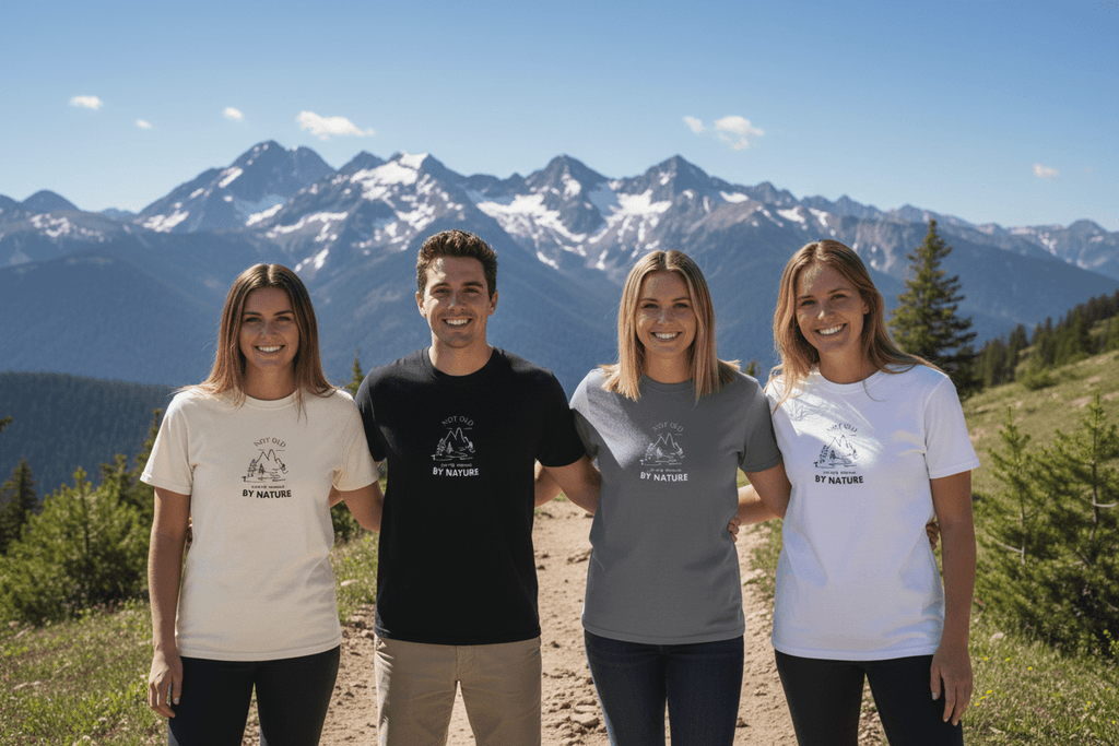 Set of graphic T-shirts in white, black, and gray with matching “BY NATURE” chest logo