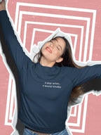 Dark crewneck sweatshirt with chest text: "a year wiser, a world kinder"