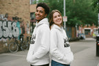 White hoodie with hood, front kangaroo pocket, and sleeve graphic