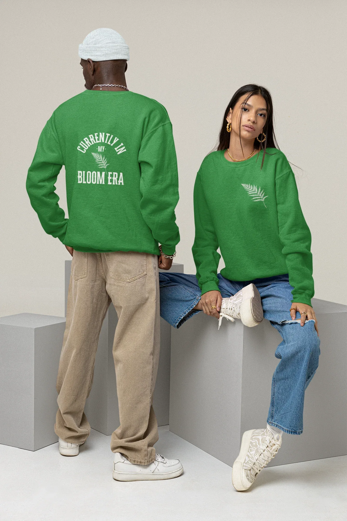 Green crewneck sweatshirt with 'Bloom Era' back text and leafy logo
