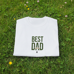 White crewneck T-shirt with green "Best Dad" typography graphic