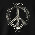 Black fabric close-up of “Good Vibes Ava” wreath graphic on hoodie