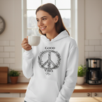 White unisex hoodie with “Good Vibes Mia” wreath graphic and front pocket