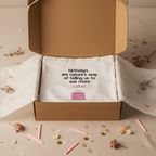 White tote bag with birthday cake quote print and pink cake graphic inside box