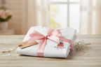 Folded white birthday cake T-shirt with bow, cake graphic and “Birthday Girl”