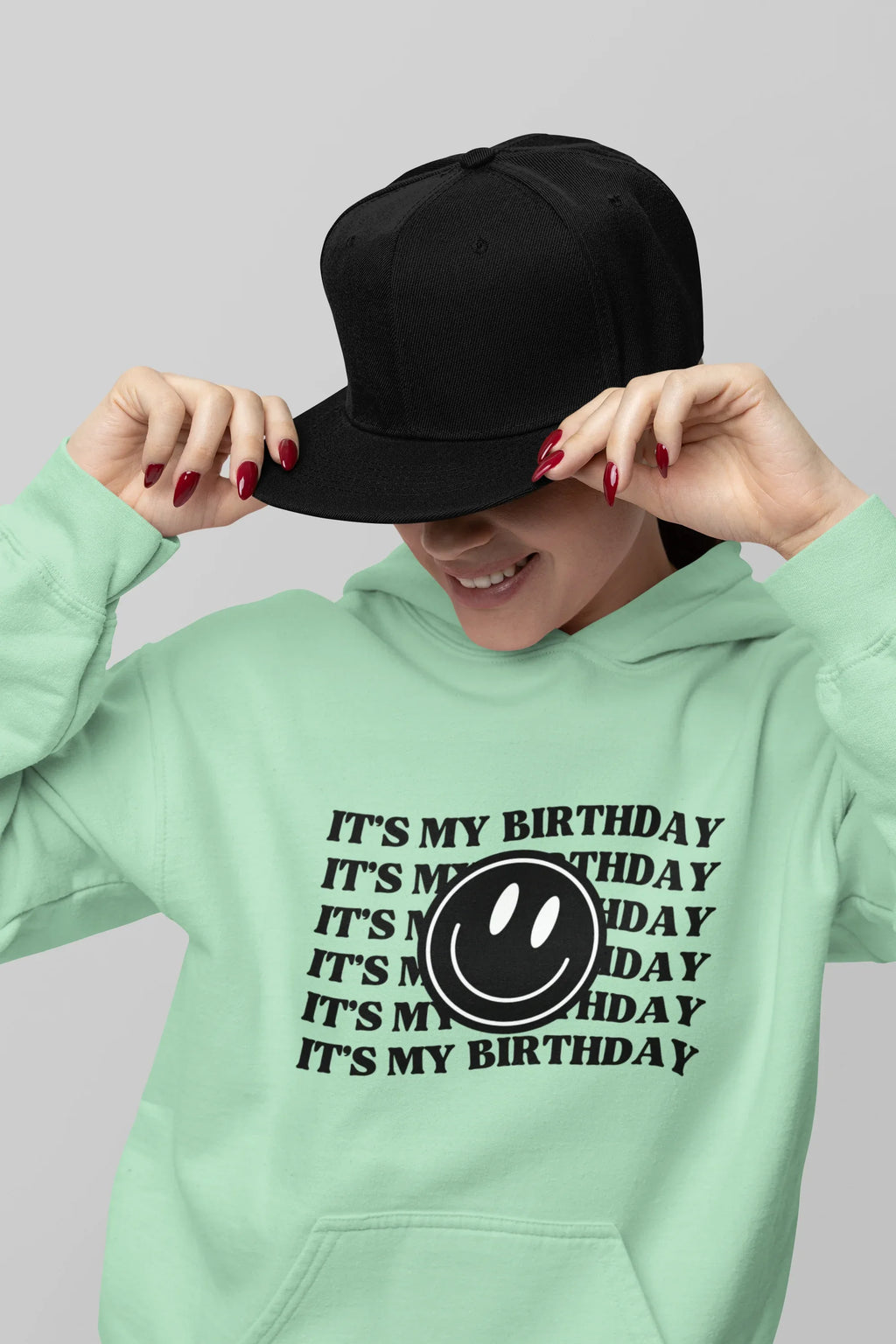Mint green hooded sweatshirt with kangaroo pocket and birthday logo graphic print